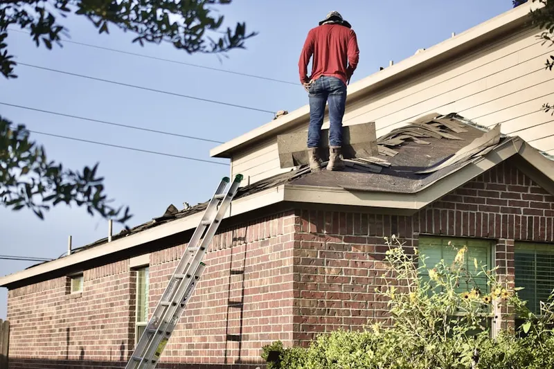 Professional roofer working on a residential roof in Sugarland